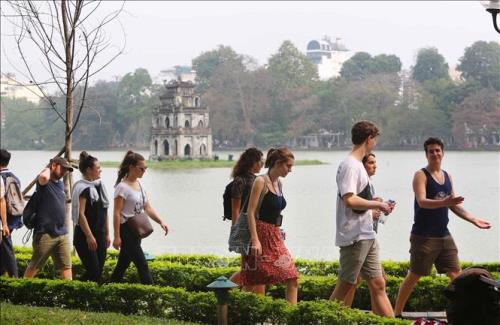 Foreign tourists by Hoàn Kiếm Lake, Hà Nội.